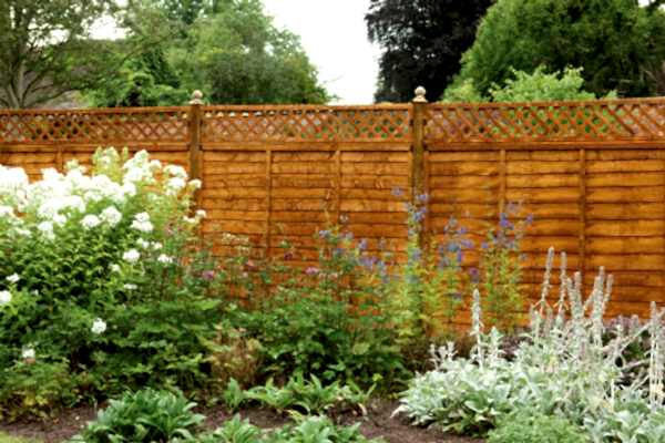 a run of fencing with a fence topper - one of our fence extension ideas