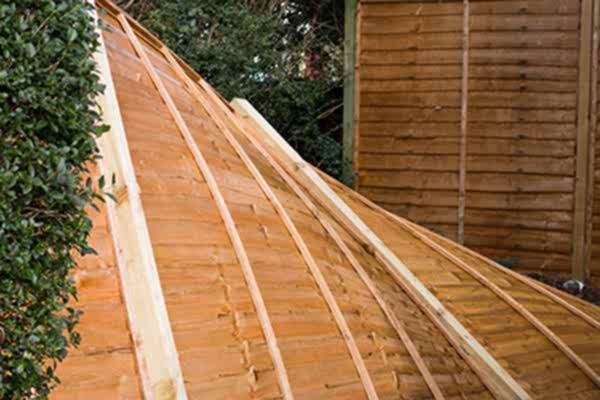 a overlap fence which has fallen over in the wind