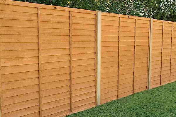 a run of dip treated fencing with long lasting fence posts that are made of concrete to prevent fence post rot