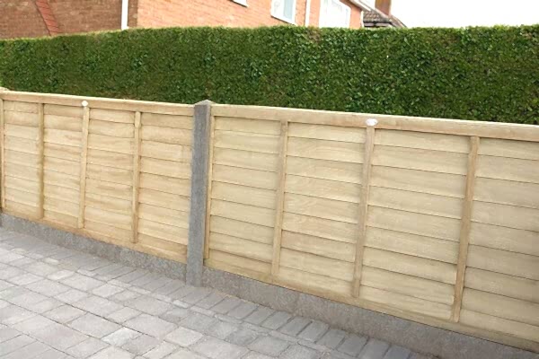 fence on driveway made up of driveway fence panels