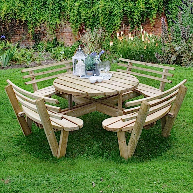 Two Forest Curved Wooden Firepit Benches, placed around a firepit, with blue and cream cushions