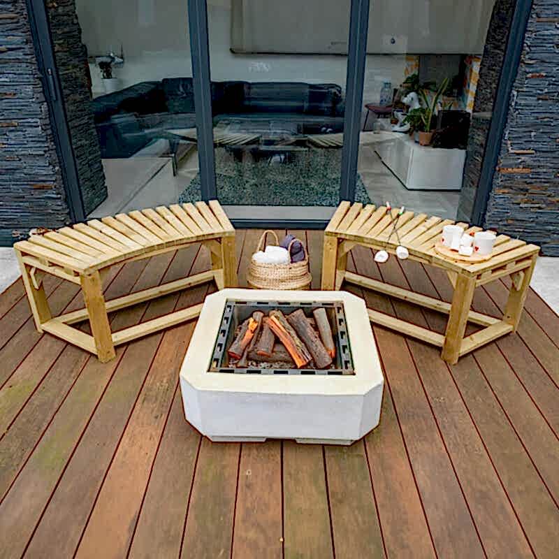Two Forest Curved Wooden Firepit Benches on decking, around a white square firepit