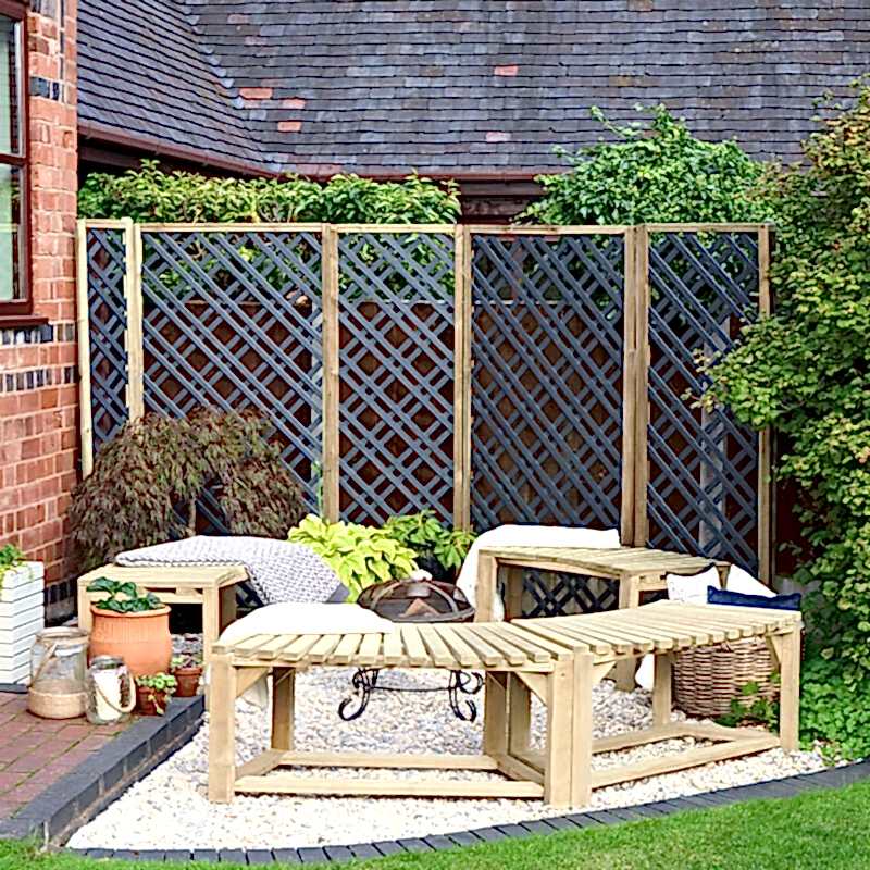 A garden privacy screen made up of multiple Forest Grey Painted Wooden Diamond Lattice Panels