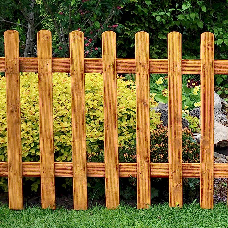 A Forest Wooden Pale Picket Fence Panel in a garden