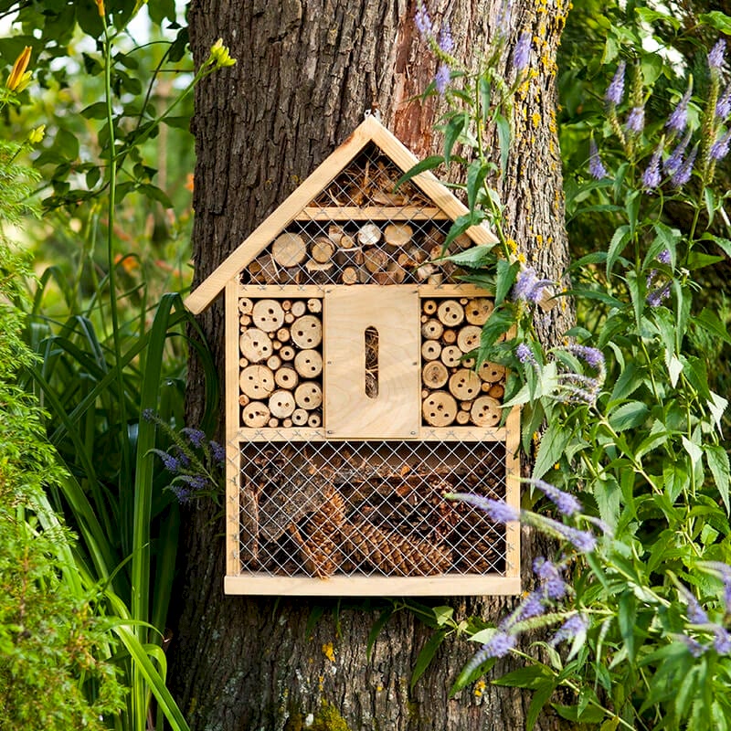 a photo of a bug hotel which compliments some eco-friendly fence panels that are made using sustainable fence materials to create eco-friendly fencing