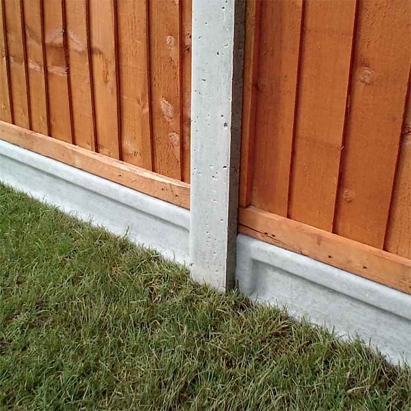concrete gravel board with concrete fence post and 2 wooden fence panels