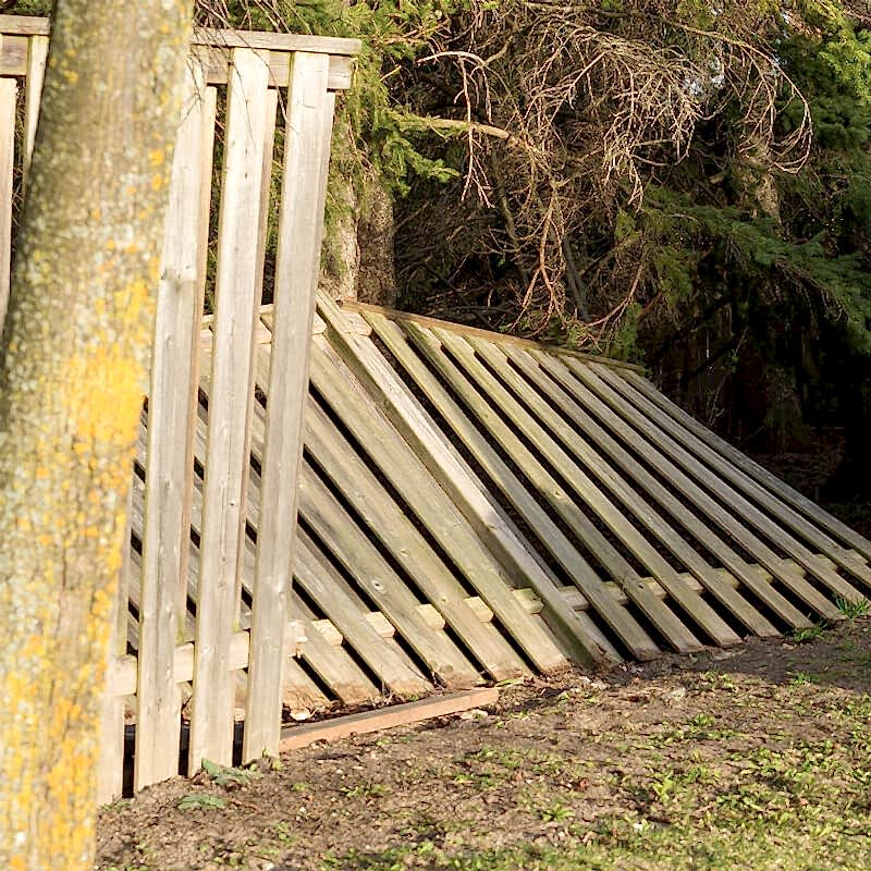 a photo showing a fence exhibiting hail damage, fence hail damage and hail damage to a wooden fence