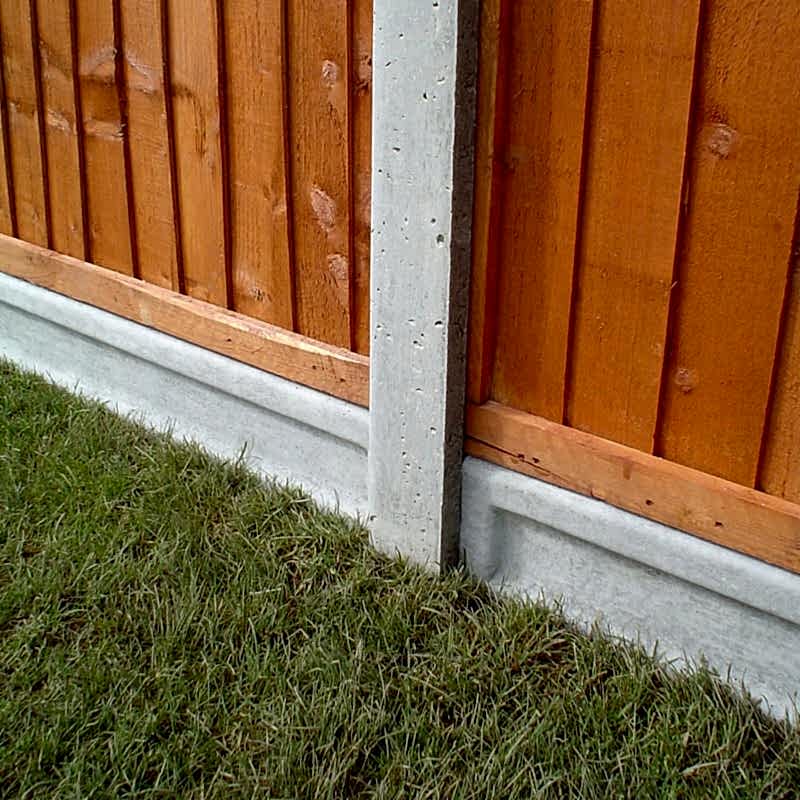 gravel boards, such as these concrete gravel boards with a concrete fence post between them and 2 wooden fence panels, are important for fence preservation