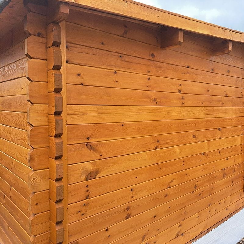 a log cabin stained with orange