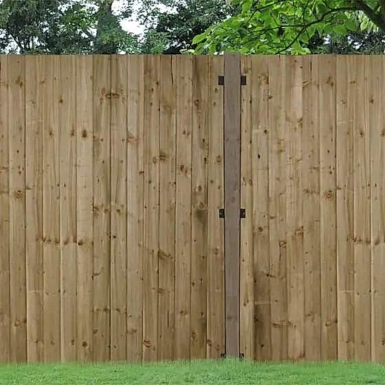 Green incised wooden fence post Green incised wooden fence post