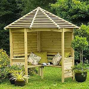 The Forest Venetian Corner Garden Arbour Seat 8x5, cushions on the seat and flanked by plant pots.